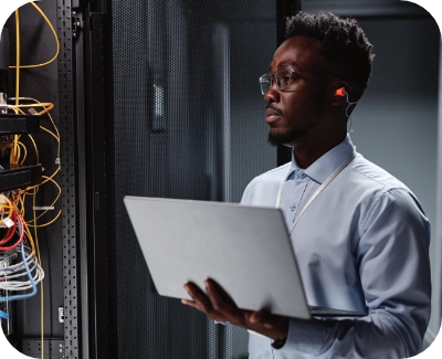 male server technician checking system status and performing regular server maintenance