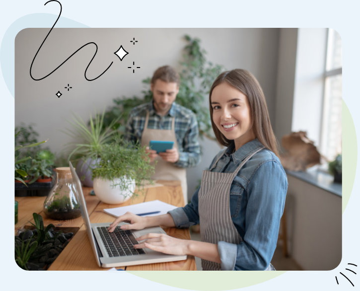 Woman with laptop smiling looking at the camera