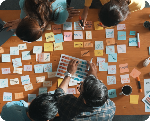 A group working at a table full of sticky notes